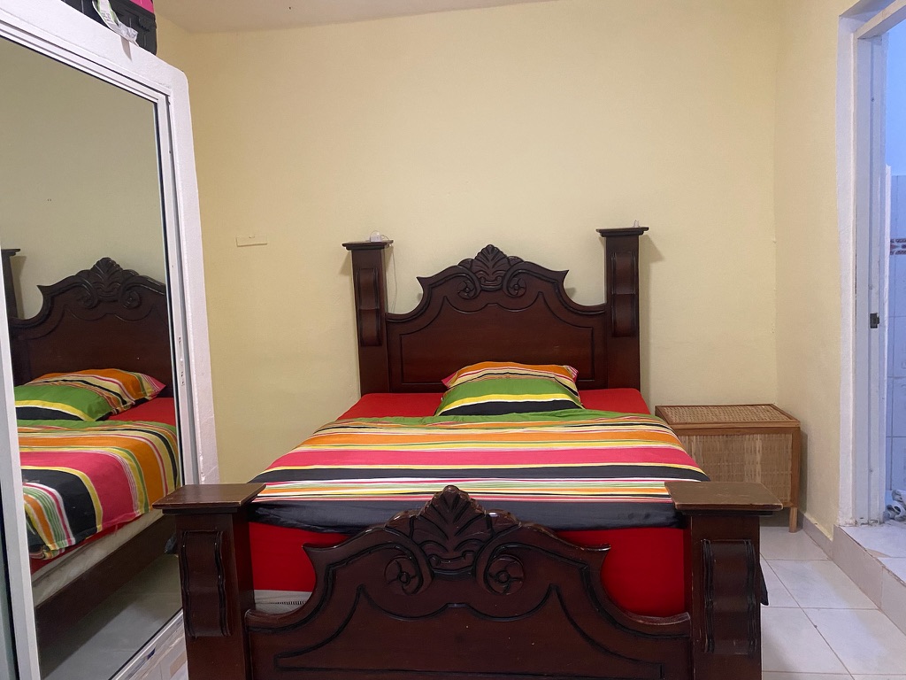 Sea Breeze Studio — cozy bedroom with AC