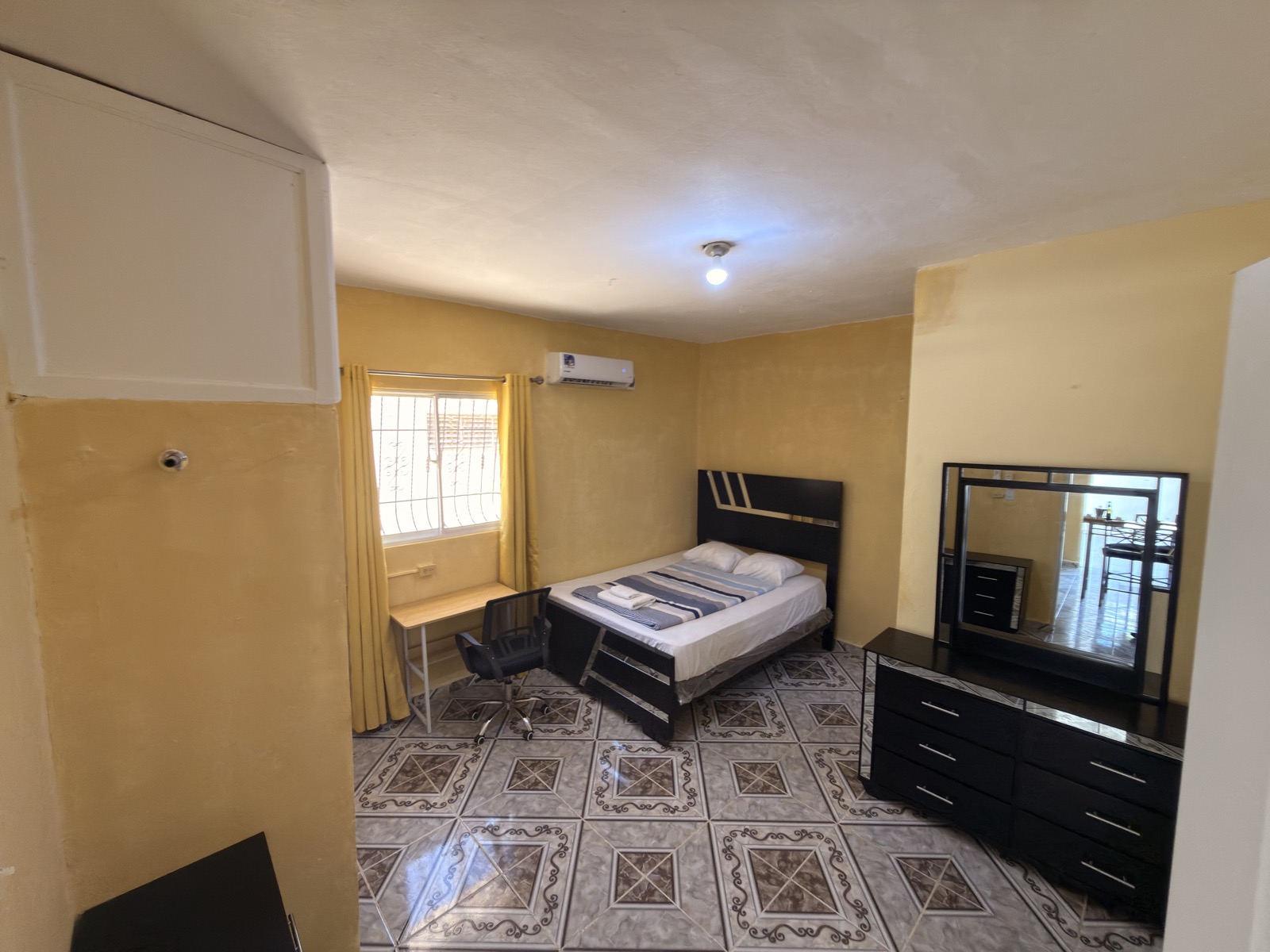 Palm Garden Suite — bedroom with AC and workspace
